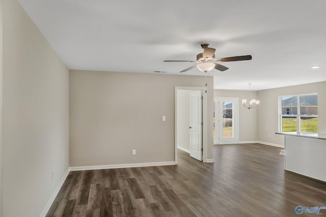 spare room with dark wood-type flooring, baseboards, and visible vents