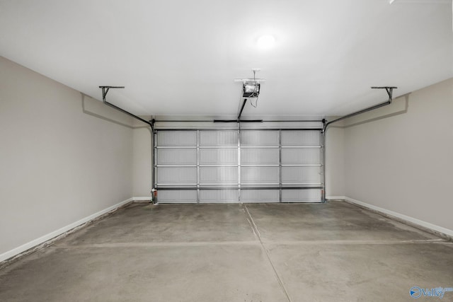 garage featuring a garage door opener and baseboards