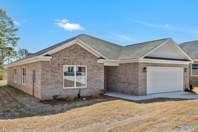 single story home featuring an attached garage, brick siding, and roof with shingles