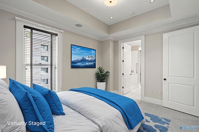 301 NE Holmes Ave Unit 404, Huntsville, AL 35801 - bedroom featuring connected bathroom, a tray ceiling, and ornamental molding