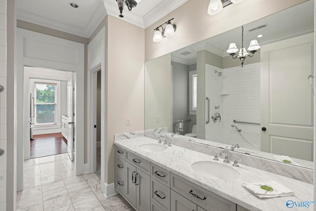 301 NE Holmes Ave Unit 404, Huntsville, AL 35801 - full bath featuring ornamental molding, double vanity, marble finish floors, a tile shower, and a chandelier