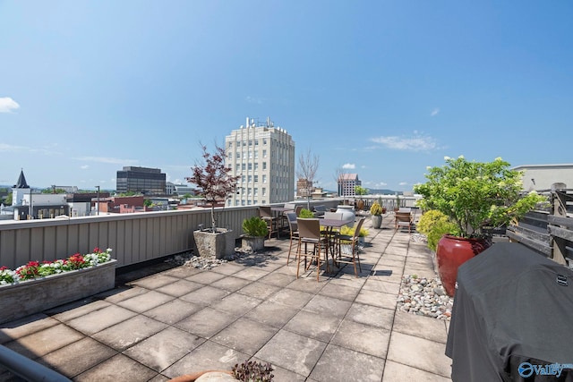 301 NE Holmes Ave Unit 404, Huntsville, AL 35801 - view of patio / terrace featuring a view of city, area for grilling, and outdoor dining space