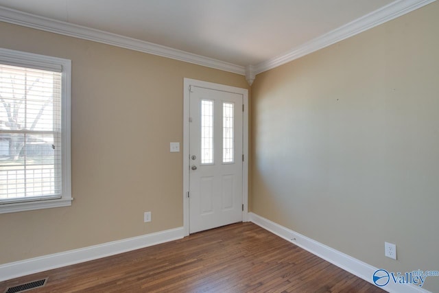 entryway with dark wood finished floors, visible vents, crown molding, and baseboards