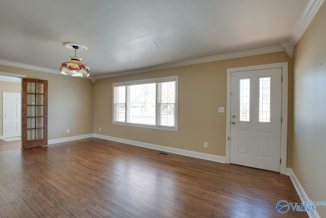 entrance foyer with wood finished floors, baseboards, and ornamental molding