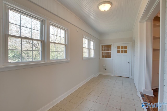 interior space featuring baseboards and light tile patterned flooring