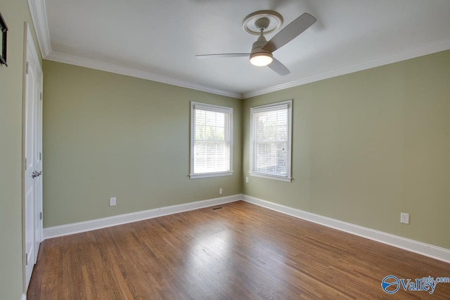 unfurnished bedroom featuring visible vents, ornamental molding, wood finished floors, baseboards, and ceiling fan