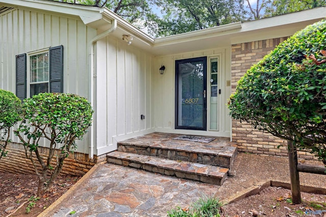 property entrance featuring brick siding