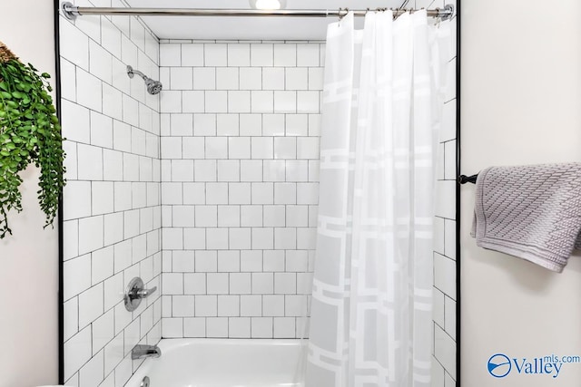 bathroom with shower / tub combo with curtain