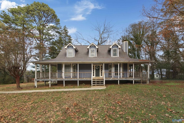 farmhouse-style home featuring covered porch and a front yard