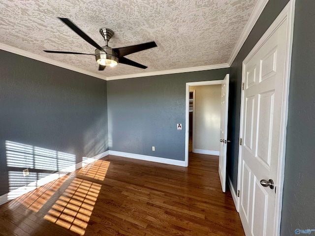 spare room featuring dark hardwood / wood-style floors, ceiling fan, ornamental molding, and a textured ceiling