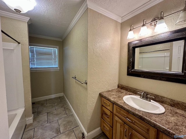 bathroom with tile patterned flooring, vanity, a textured ceiling, and ornamental molding