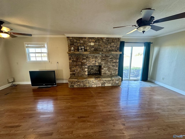 unfurnished living room featuring ornamental molding, a healthy amount of sunlight, and wood-type flooring