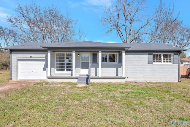 ranch-style home featuring a garage, concrete driveway, brick siding, and a front lawn