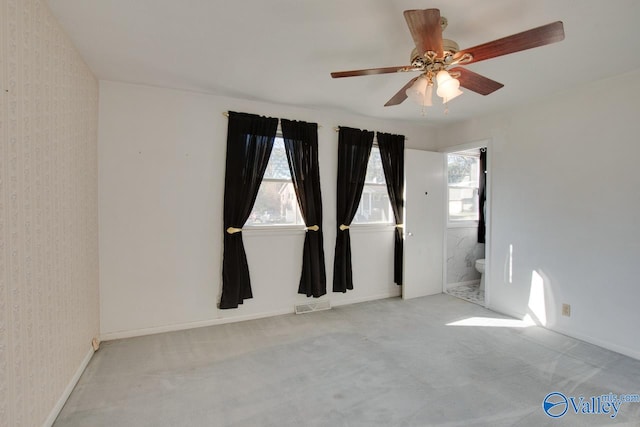 spare room featuring ceiling fan and light colored carpet