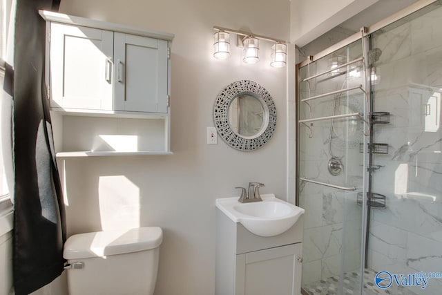 bathroom featuring vanity, toilet, and walk in shower