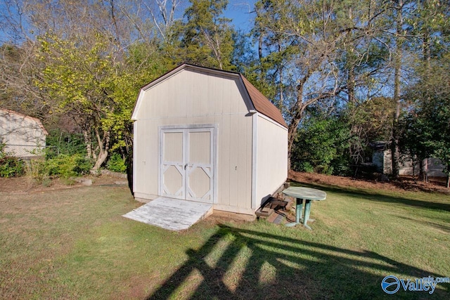 view of outdoor structure featuring a lawn