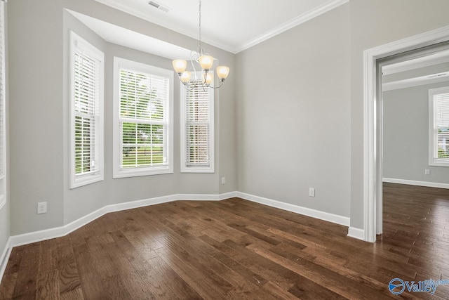 unfurnished room featuring crown molding, dark hardwood / wood-style floors, and a notable chandelier