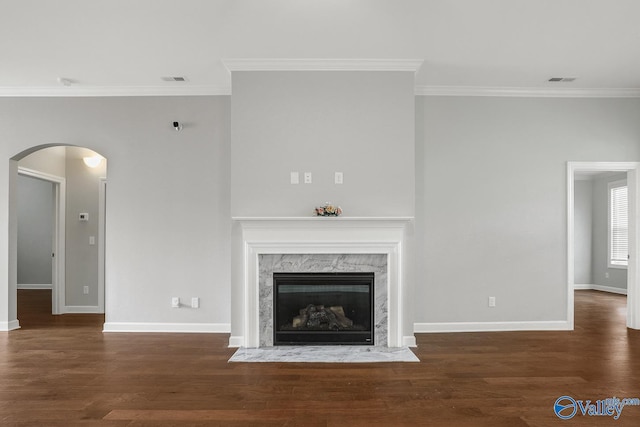 unfurnished living room with crown molding, dark wood-type flooring, and a high end fireplace