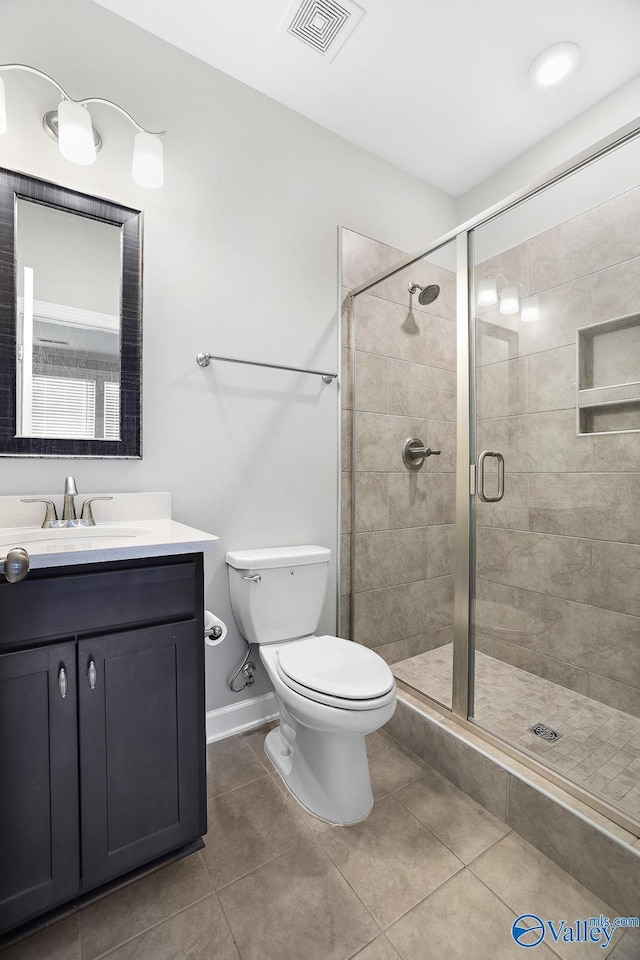 bathroom with vanity, an enclosed shower, tile patterned floors, and toilet