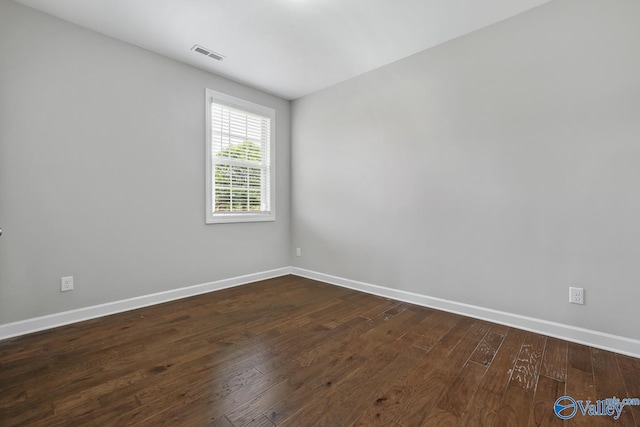 unfurnished room with dark hardwood / wood-style flooring