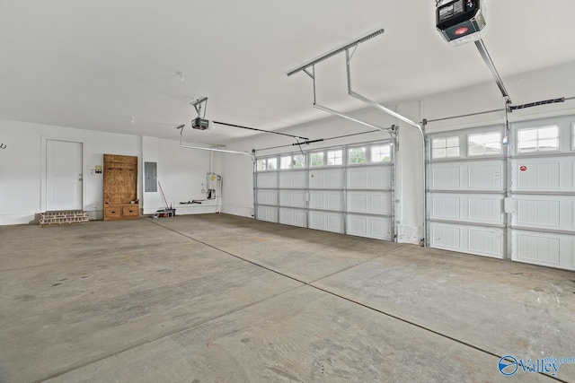 garage with a garage door opener and electric panel