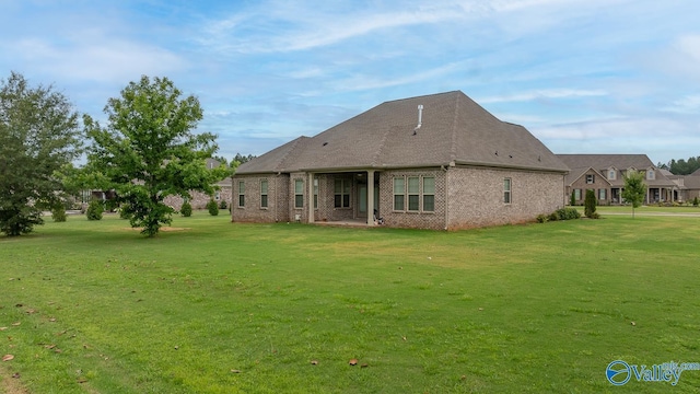 back of property featuring a yard