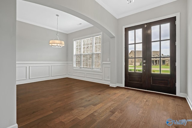 foyer featuring crown molding, dark hardwood / wood-style flooring, and french doors