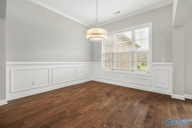 spare room with ornamental molding and dark hardwood / wood-style flooring