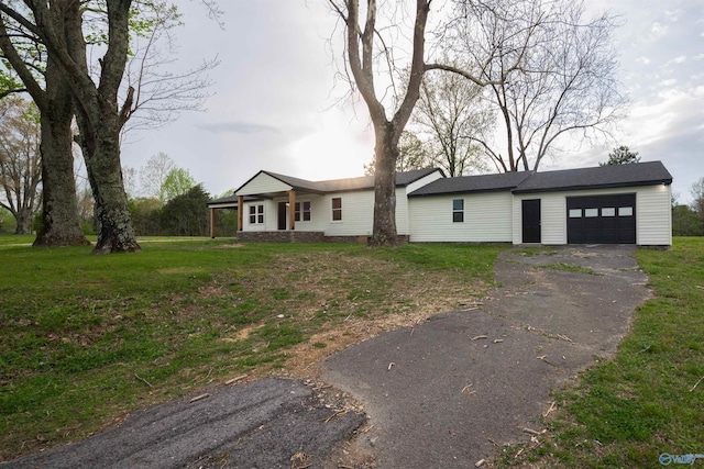 single story home featuring a garage and a front yard