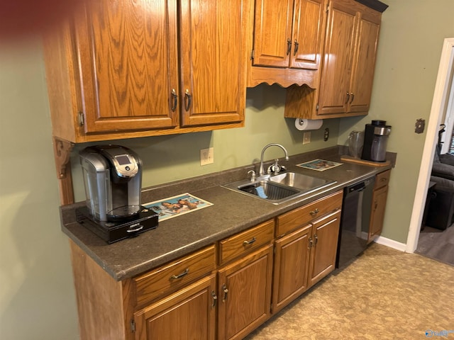 1812 Kathy Lane Ct, Decatur, AL 35603 - kitchen featuring a sink, dishwasher, brown cabinets, and dark countertops