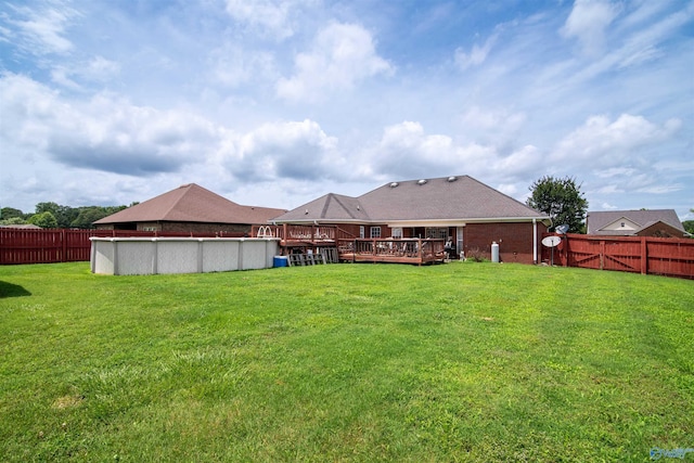 114 Sandi Paige Ln, Huntsville, AL 35811 - rear view of house with a wooden deck, a fenced backyard, and brick siding