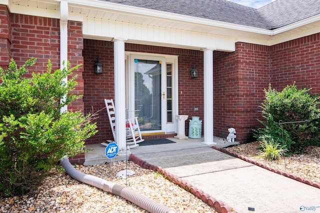 114 Sandi Paige Ln, Huntsville, AL 35811 - view of exterior entry featuring a shingled roof, brick siding, and covered porch