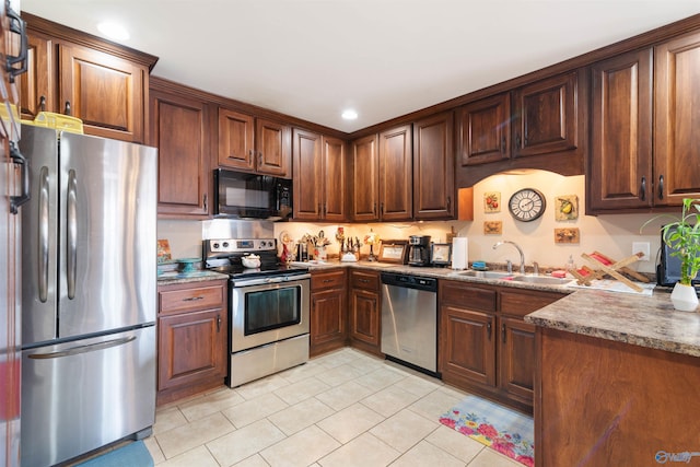 114 Sandi Paige Ln, Huntsville, AL 35811 - kitchen with appliances with stainless steel finishes, light tile patterned floors, and recessed lighting
