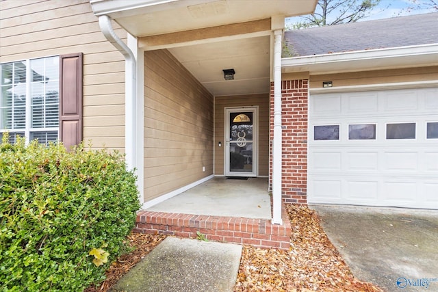 view of exterior entry with a garage