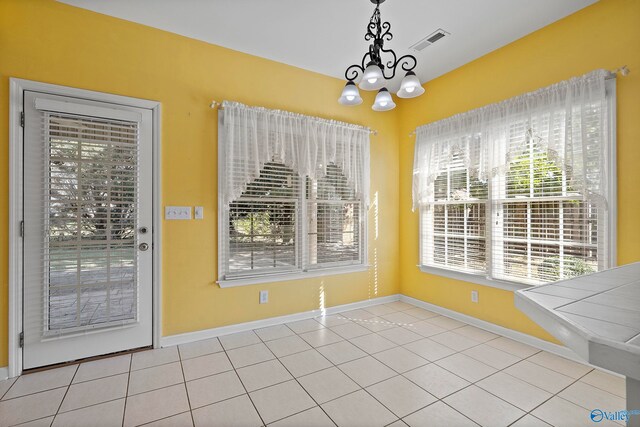 unfurnished dining area with light tile patterned flooring and a wealth of natural light