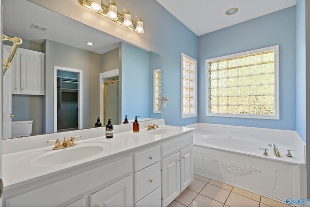 full bathroom featuring tile patterned floors, toilet, vanity, and shower with separate bathtub