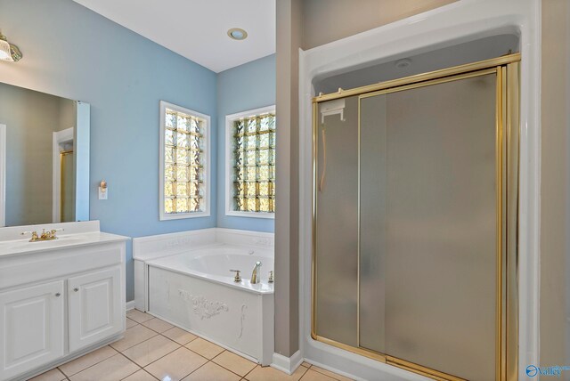 bathroom with tile patterned flooring, vanity, and plus walk in shower