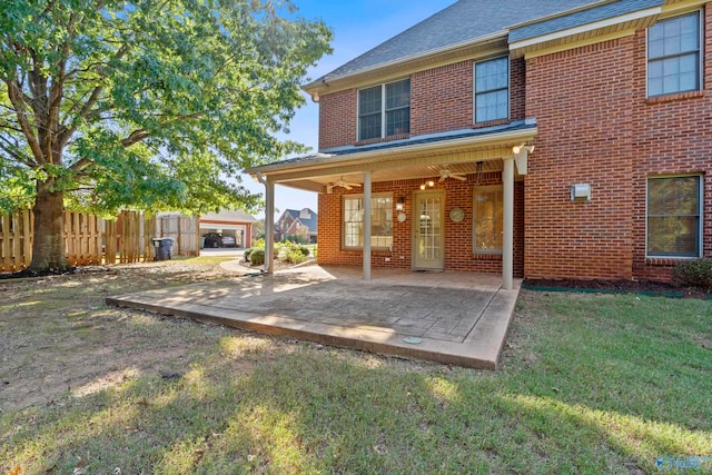 rear view of property featuring a yard, a patio area, and ceiling fan