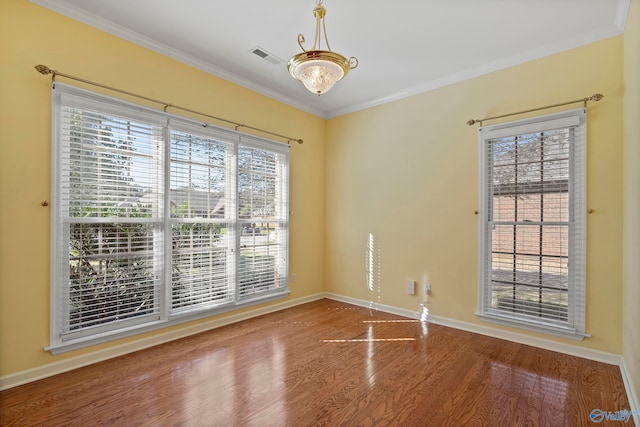 unfurnished room with ornamental molding and hardwood / wood-style floors