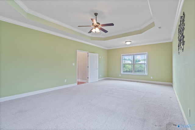 unfurnished room with ornamental molding, a raised ceiling, light carpet, and ceiling fan