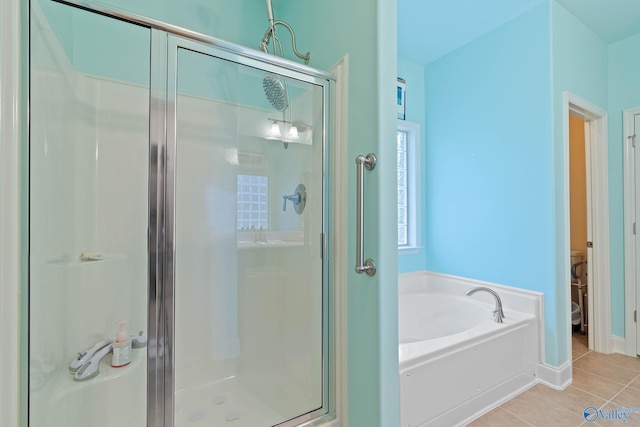 bathroom with separate shower and tub and tile patterned flooring