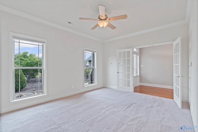 empty room with french doors, plenty of natural light, and ceiling fan