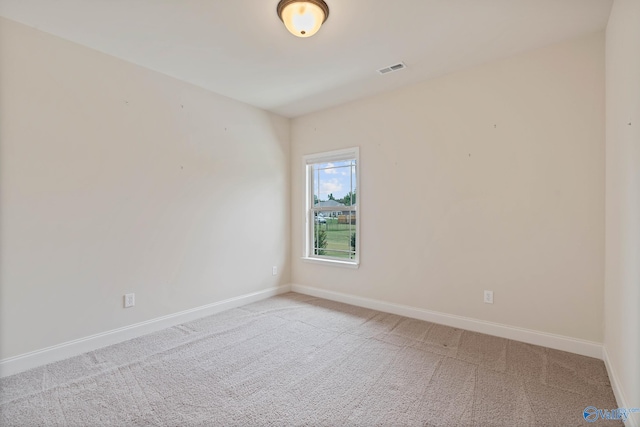 spare room featuring light colored carpet