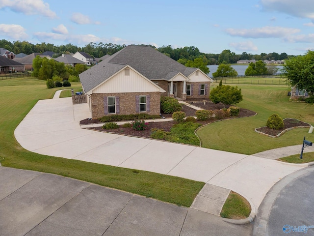 ranch-style house with a front yard and a water view