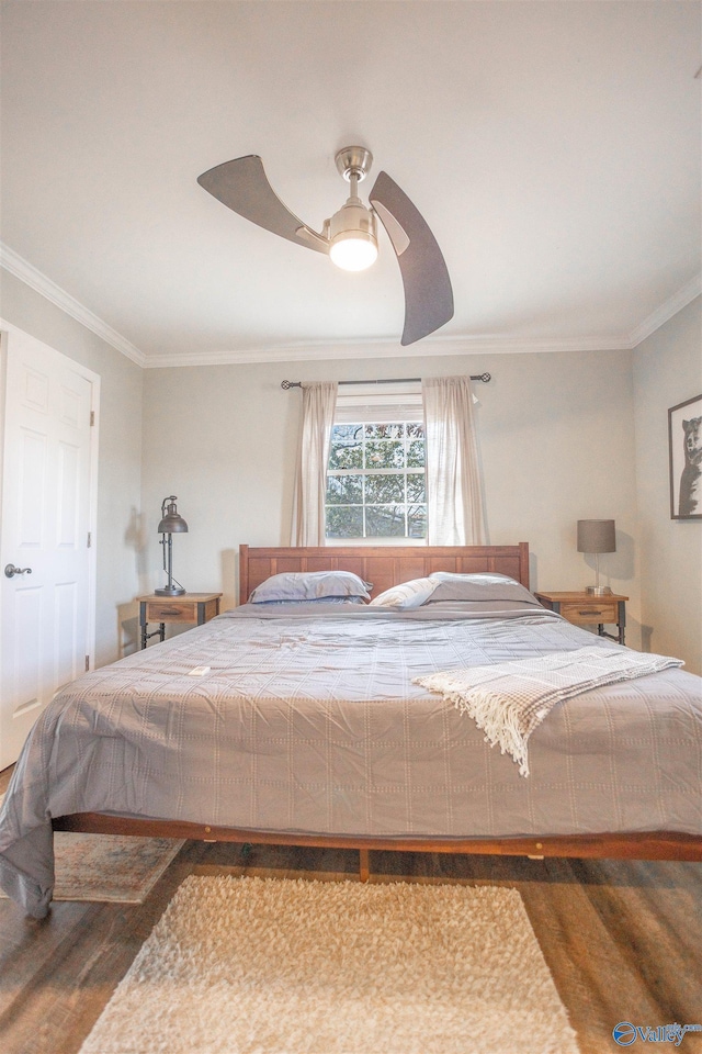 bedroom with ceiling fan, wood-type flooring, and ornamental molding