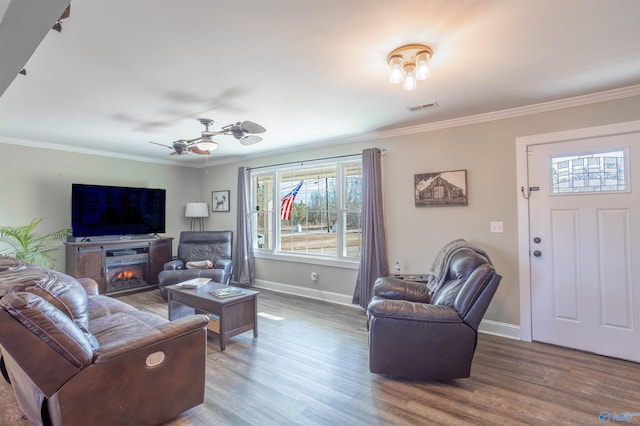 living room featuring hardwood / wood-style flooring, ornamental molding, and ceiling fan