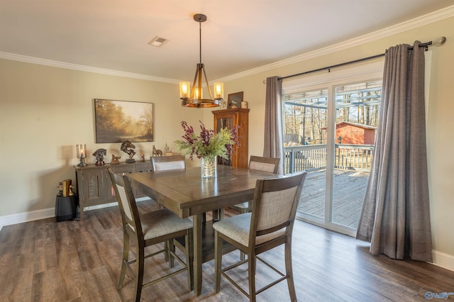 dining space with dark hardwood / wood-style flooring, crown molding, and an inviting chandelier