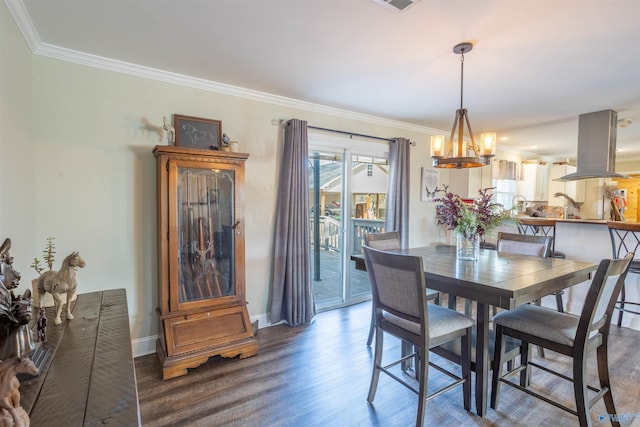 dining area featuring ornamental molding and dark hardwood / wood-style floors