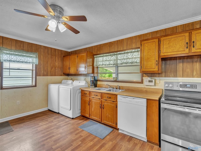 17441 E Limestone Rd, Athens, AL 35613 - kitchen featuring white dishwasher, stainless steel electric range, washing machine and clothes dryer, ornamental molding, and a sink