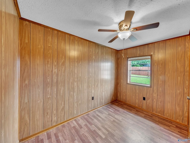 17441 E Limestone Rd, Athens, AL 35613 - spare room with wood finished floors, baseboards, ceiling fan, a textured ceiling, and wooden walls